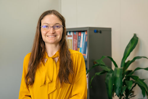 Heather Nelson sits at a desk with a computer