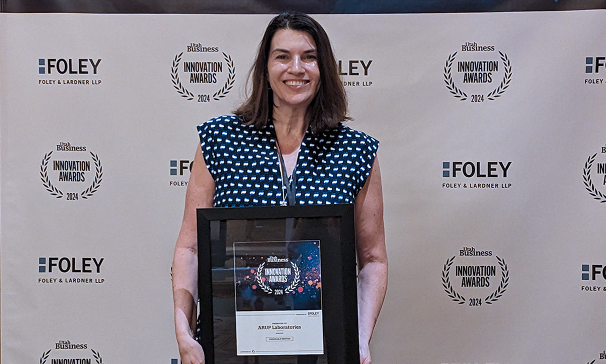 Tracy George holds a plaque.