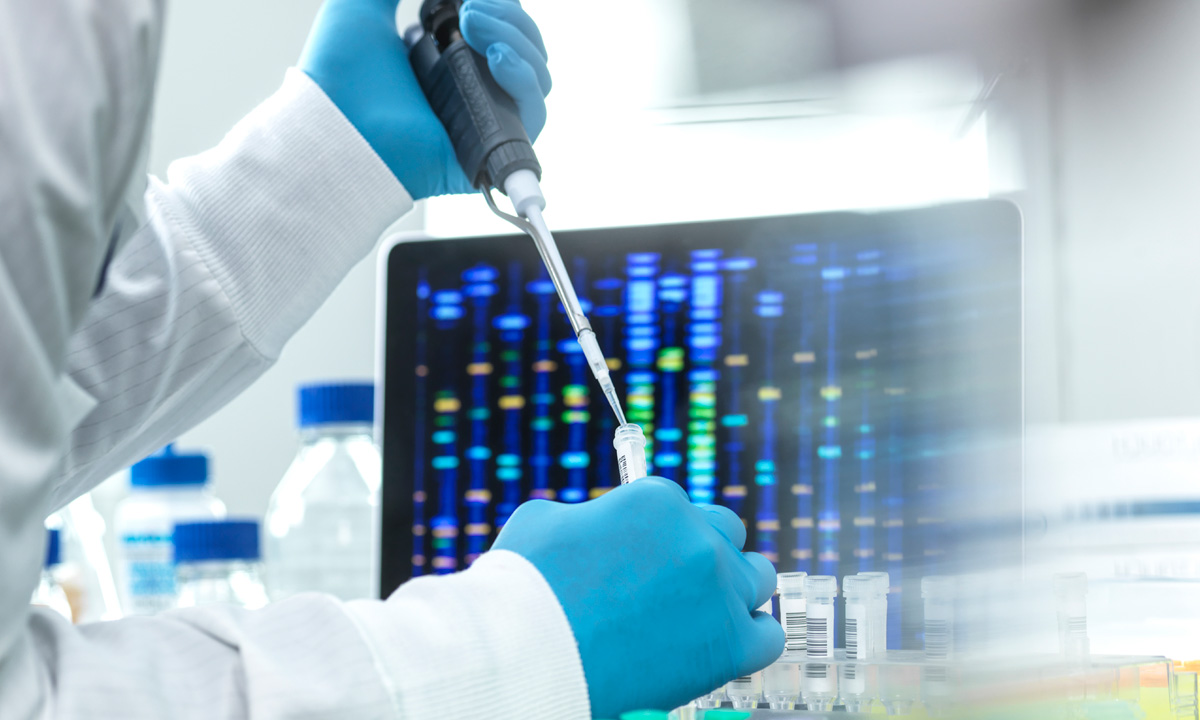 Gloved hands hold a sample and a laboratory instrument while performing germline testing.